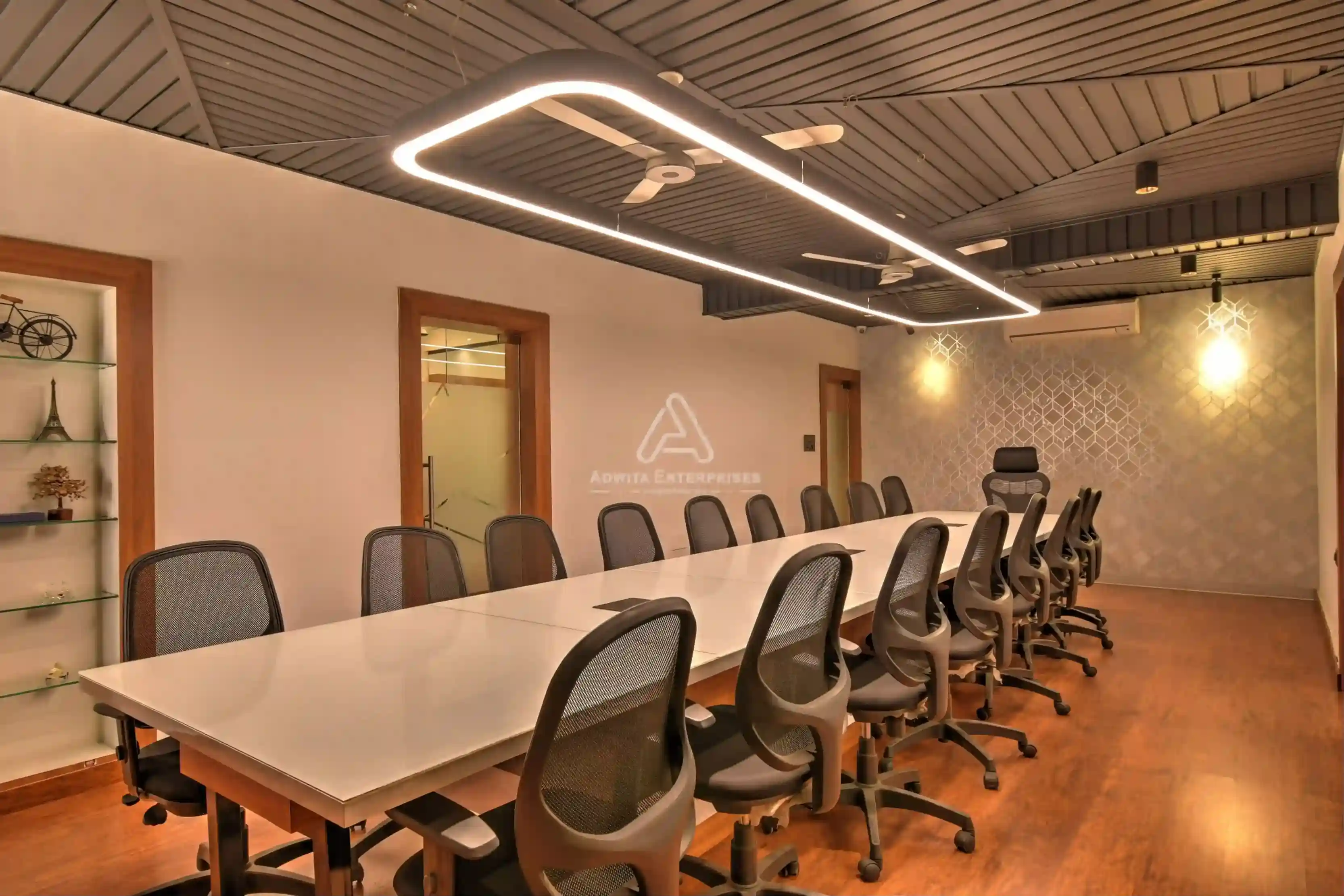 Meeting room with large conference table, ergonomic chairs, and modern lighting