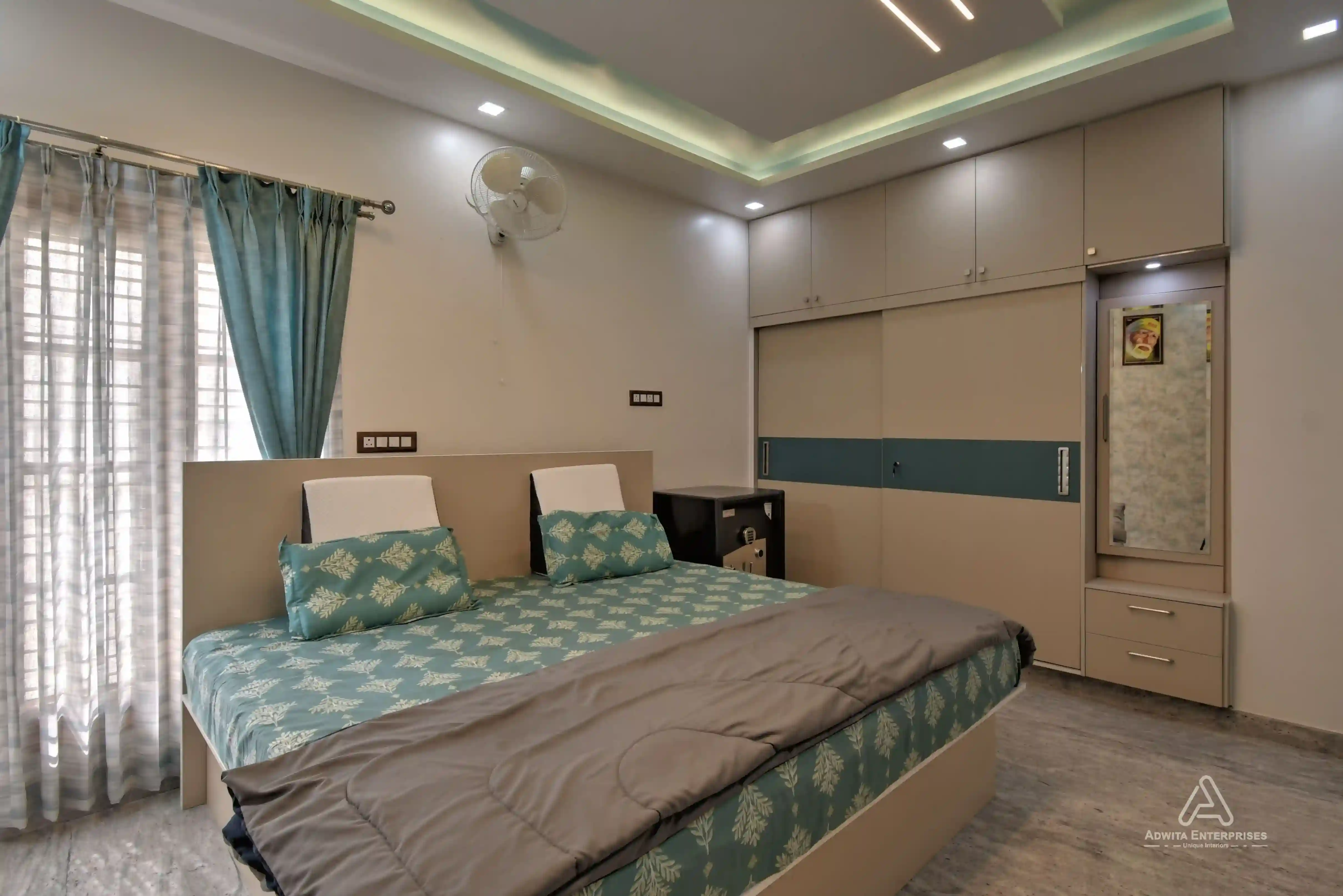 Bedroom featuring queen-size bed, bedside tables, and built-in wardrobe