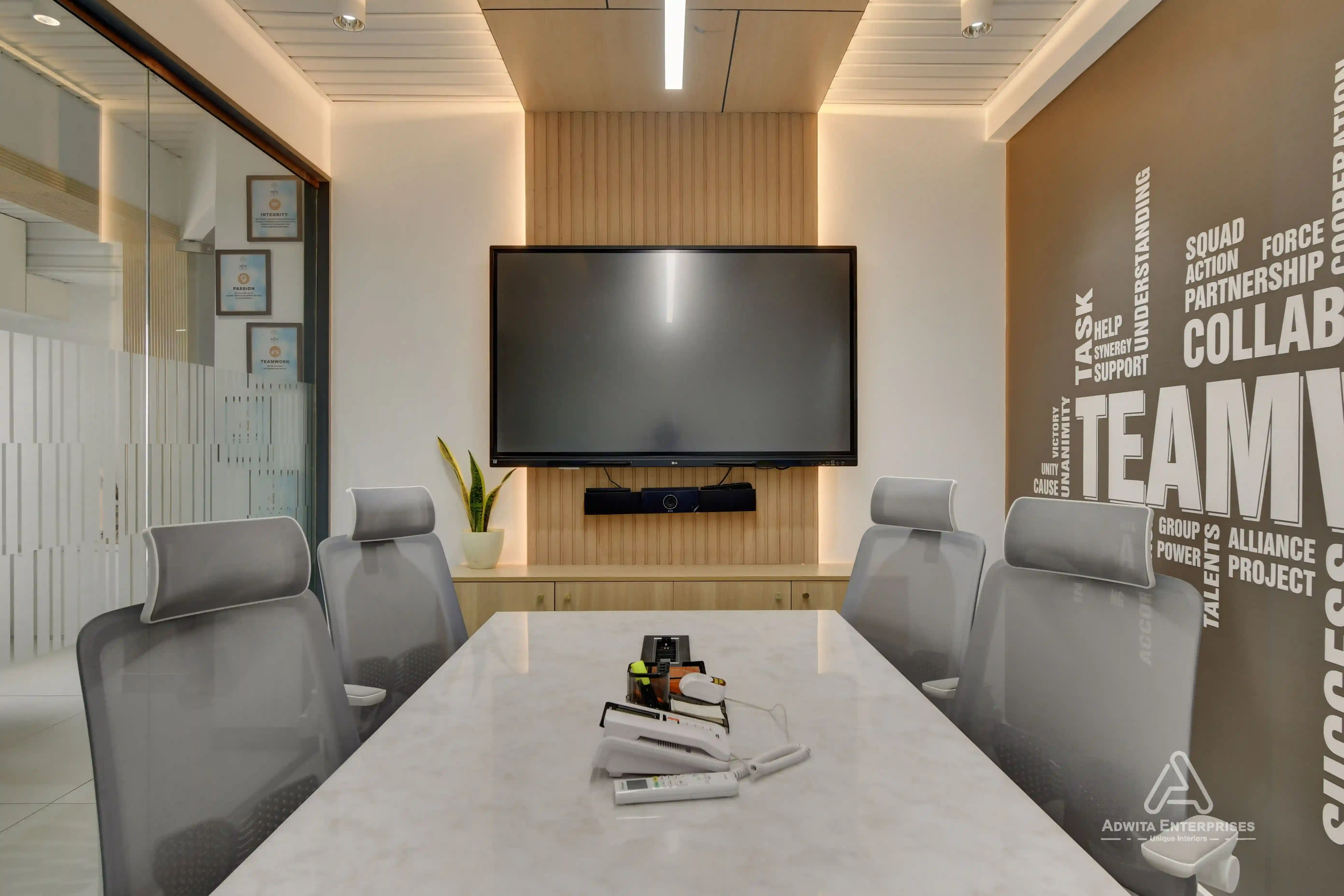 Discussion room with large conference table, ergonomic chairs, and modern lighting